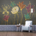 Fleurs stylisées au trait doré sur fond gris anthracite dans un salon