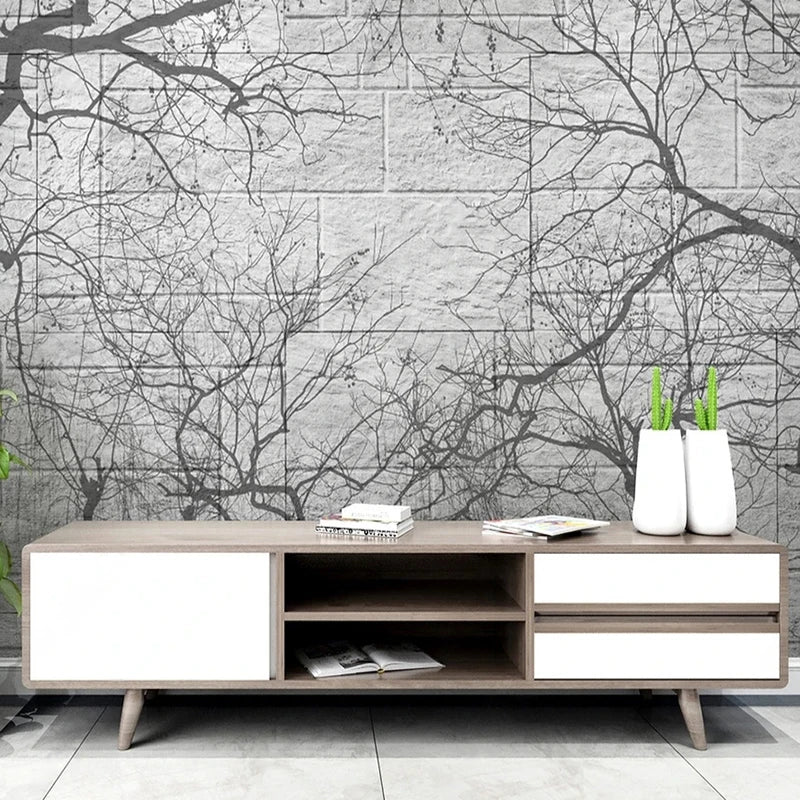 Papier peint panoramique de branches noires sur mur de pierre grise dans un salon
